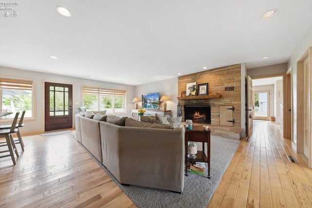 3999 NE Catawba Rd Unit 29, Port Clinton, OH 43452 - living room featuring plenty of natural light, a stone fireplace, recessed lighting, and light wood-style flooring