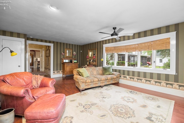 133 E Forest St, Clyde, OH 43410 - living area featuring wallpapered walls, wood finished floors, a ceiling fan, and baseboards
