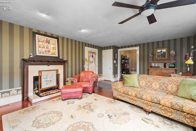 133 E Forest St, Clyde, OH 43410 - living room featuring wood finished floors, wallpapered walls, a ceiling fan, a tile fireplace, and recessed lighting