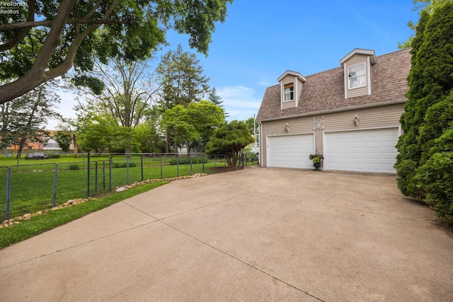 133 E Forest St, Clyde, OH 43410 - view of property exterior featuring a garage, roof with shingles, and driveway