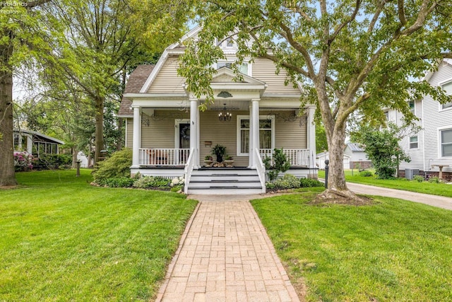 133 E Forest St, Clyde, OH 43410 - view of front of property featuring a porch, a front lawn, and central air condition unit