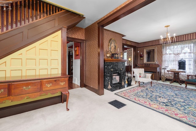 133 E Forest St, Clyde, OH 43410 - living area featuring wallpapered walls, carpet flooring, a chandelier, a premium fireplace, and baseboards