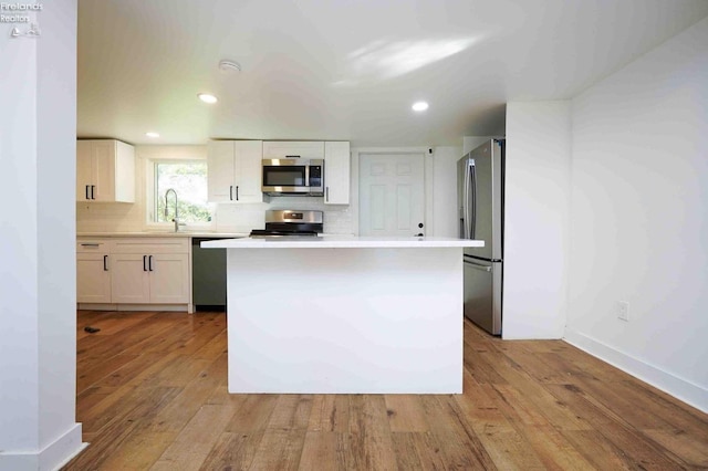 612 2nd St, Fremont, OH 43420 - kitchen featuring stainless steel appliances, white cabinetry, light countertops, light wood-style floors, and recessed lighting