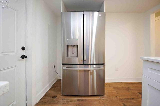 612 2nd St, Fremont, OH 43420 - kitchen featuring stainless steel fridge with ice dispenser, wood finished floors, and baseboards