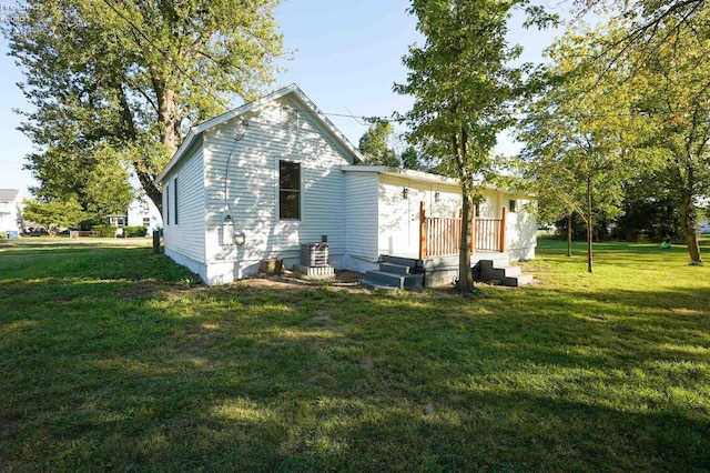 612 2nd St, Fremont, OH 43420 - back of house featuring a yard, a wooden deck, and cooling unit