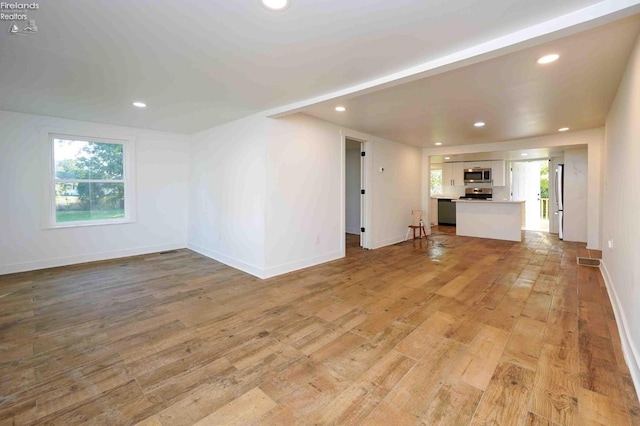 612 2nd St, Fremont, OH 43420 - unfurnished living room with recessed lighting, light wood-style floors, and baseboards