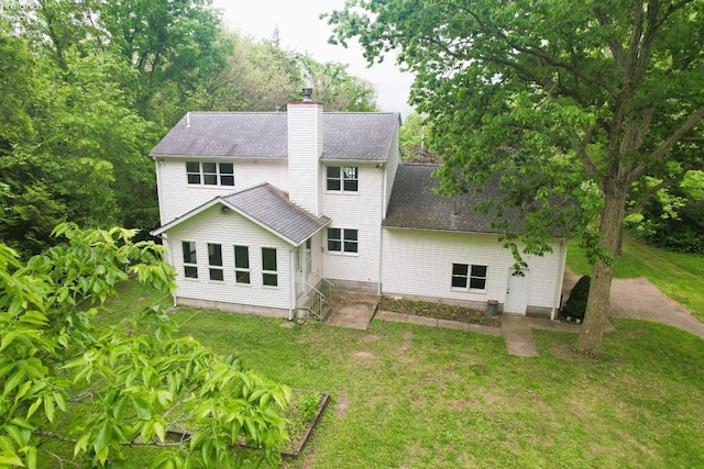 9343 E Bayshore Rd, Marblehead, OH 43440 - rear view of house featuring a chimney, a lawn, and roof with shingles
