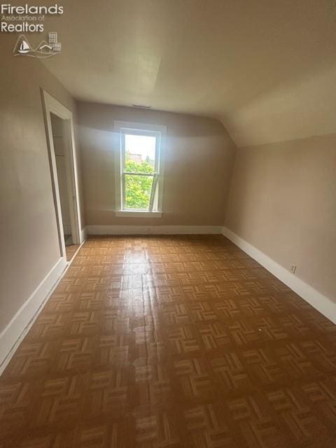 201 Heter St, Bellevue, OH 44811 - additional living space featuring baseboards and vaulted ceiling