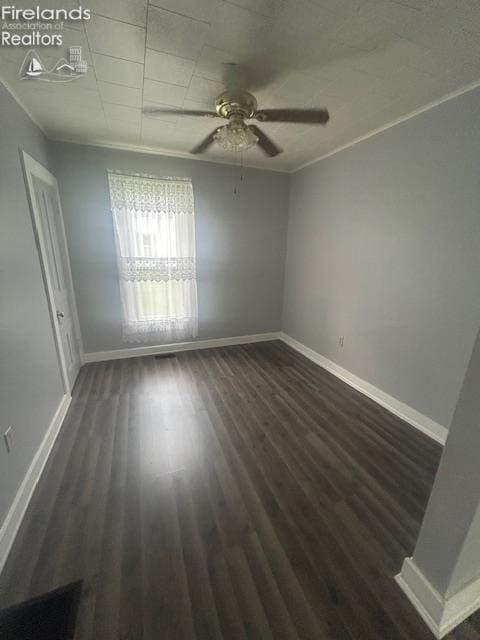 201 Heter St, Bellevue, OH 44811 - spare room featuring baseboards, dark wood-type flooring, and ceiling fan