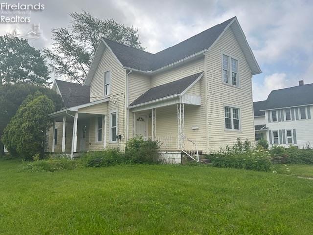 201 Heter St, Bellevue, OH 44811 - view of home's exterior featuring covered porch and a yard