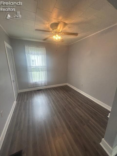 201 Heter St, Bellevue, OH 44811 - spare room with crown molding, baseboards, ceiling fan, and dark wood finished floors