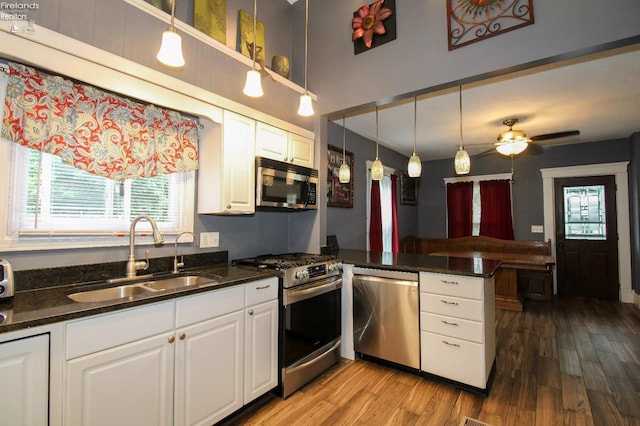134 Hobson St, Bellevue, OH 44811 - kitchen with appliances with stainless steel finishes, a sink, a peninsula, and white cabinetry