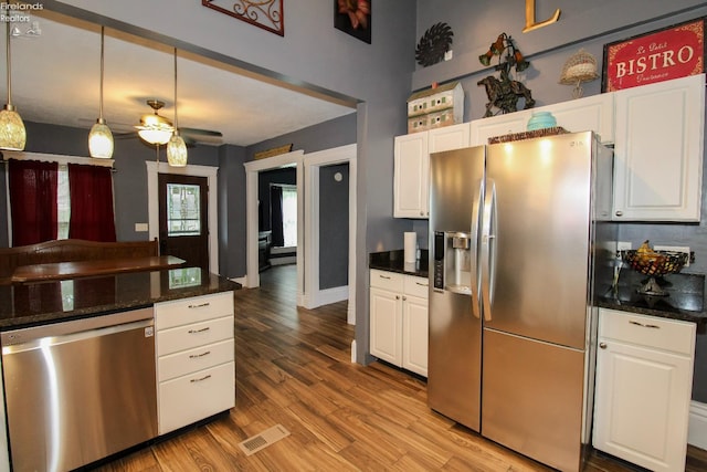 134 Hobson St, Bellevue, OH 44811 - kitchen with appliances with stainless steel finishes, white cabinetry, light wood-style floors, ceiling fan, and pendant lighting