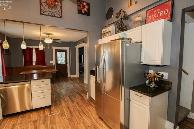 134 Hobson St, Bellevue, OH 44811 - kitchen featuring appliances with stainless steel finishes, wood finished floors, white cabinetry, a ceiling fan, and pendant lighting