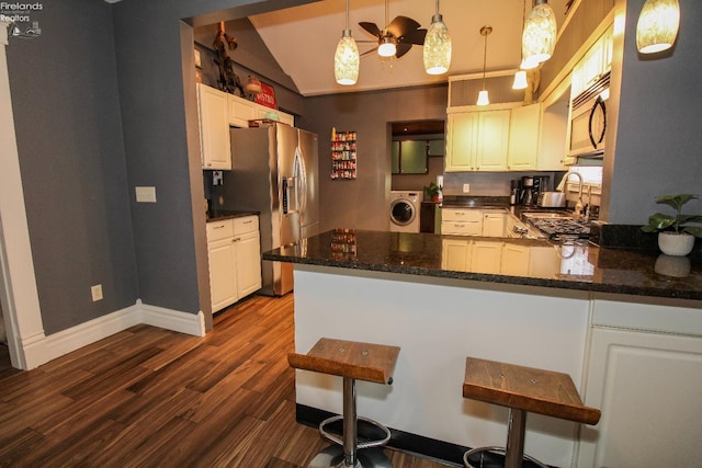 134 Hobson St, Bellevue, OH 44811 - kitchen with stainless steel fridge with ice dispenser, washer / clothes dryer, lofted ceiling, dark wood-type flooring, and a sink
