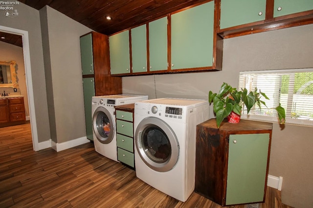 134 Hobson St, Bellevue, OH 44811 - laundry area featuring cabinet space, independent washer and dryer, dark wood-style flooring, wooden ceiling, and baseboards