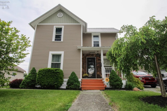 134 Hobson St, Bellevue, OH 44811 - view of front of house featuring a front yard, a porch, and metal roof