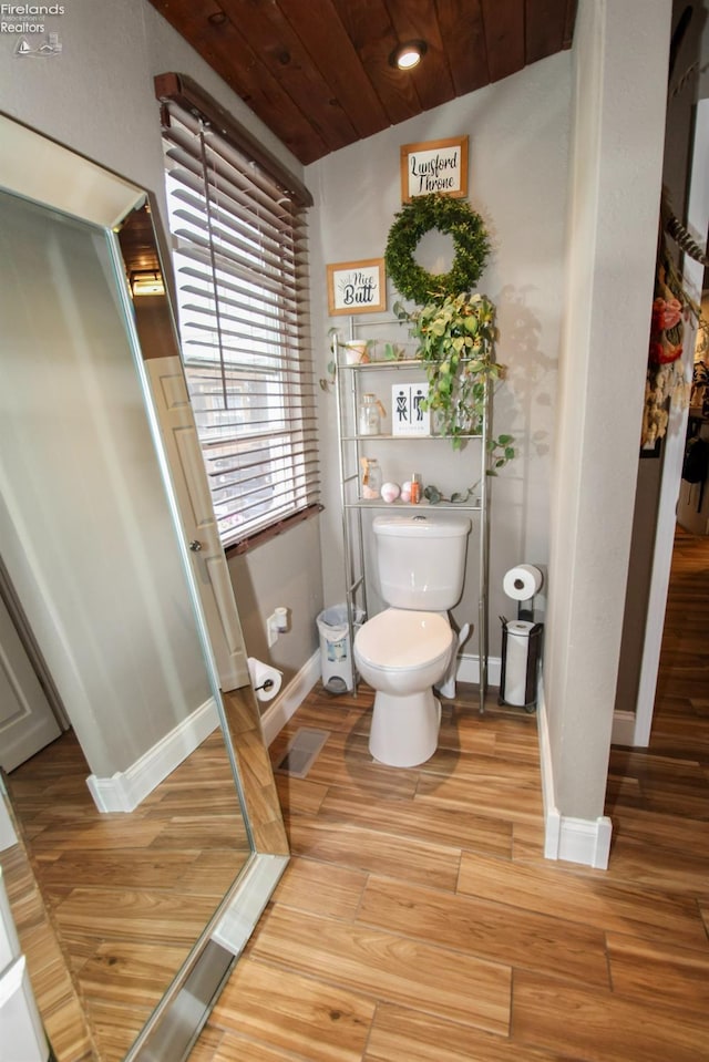 134 Hobson St, Bellevue, OH 44811 - bathroom with toilet, wood finished floors, baseboards, and wood ceiling