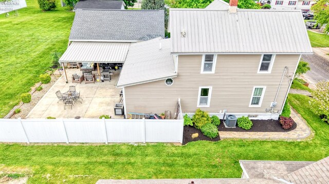 134 Hobson St, Bellevue, OH 44811 - back of property with a patio area, central AC unit, metal roof, and a chimney