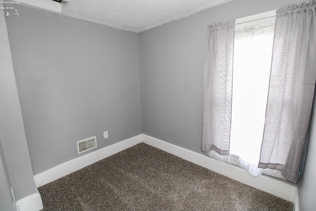 134 Hobson St, Bellevue, OH 44811 - unfurnished room featuring dark carpet, healthy amount of natural light, and baseboards