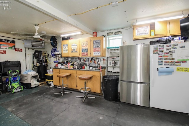 134 Hobson St, Bellevue, OH 44811 - garage featuring freestanding refrigerator and a workshop area