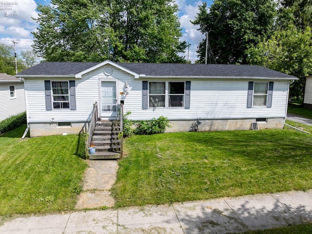 725 N 5th St, Fremont, OH 43420 - manufactured / mobile home featuring a front yard, a shingled roof, and crawl space