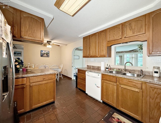 31 Mohawk St, Tiffin, OH 44883 - kitchen featuring dishwasher, a sink, brick patterned floors, a ceiling fan, and arched walkways