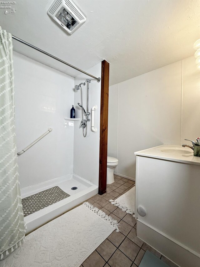31 Mohawk St, Tiffin, OH 44883 - bathroom with tile patterned flooring, toilet, vanity, and a shower with shower curtain