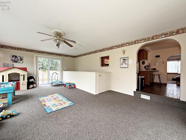 31 Mohawk St, Tiffin, OH 44883 - game room with a ceiling fan, dark carpet, arched walkways, and baseboards