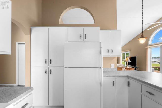 6485 E Harbor Rd Unit 38, Marblehead, OH 43440 - kitchen featuring freestanding refrigerator, light countertops, white cabinetry, pendant lighting, and vaulted ceiling