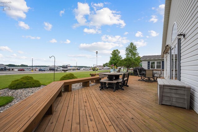 6485 E Harbor Rd Unit 38, Marblehead, OH 43440 - deck featuring outdoor dining space, a yard, and a grill
