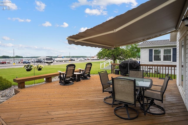 6485 E Harbor Rd Unit 38, Marblehead, OH 43440 - wooden terrace featuring outdoor dining area, a yard, and area for grilling