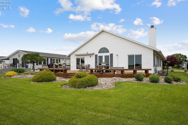6485 E Harbor Rd Unit 38, Marblehead, OH 43440 - rear view of house featuring a wooden deck, a lawn, and a chimney