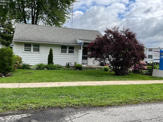 52 Prospect St, New London, OH 44851 - view of front of home with a front lawn and a shingled roof