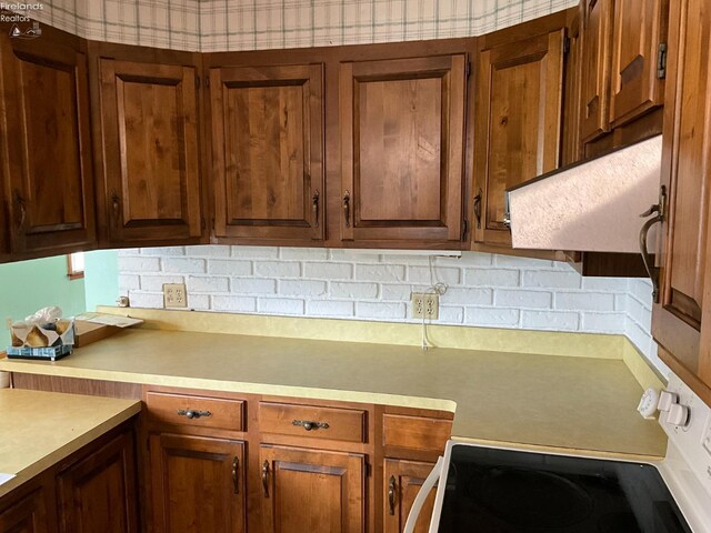 52 Prospect St, New London, OH 44851 - kitchen with white range with electric cooktop, light countertops, and backsplash