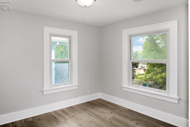 713 Madison St, Port Clinton, OH 43452 - spare room with baseboards and wood finished floors