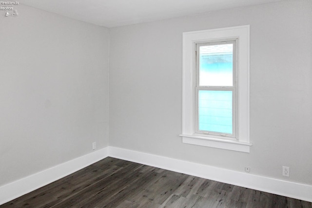 713 Madison St, Port Clinton, OH 43452 - spare room featuring dark wood-style floors and baseboards