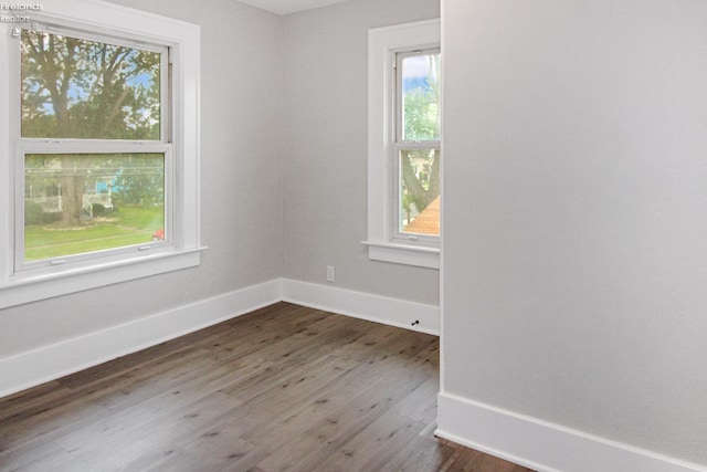 713 Madison St, Port Clinton, OH 43452 - unfurnished room with dark wood-type flooring and baseboards