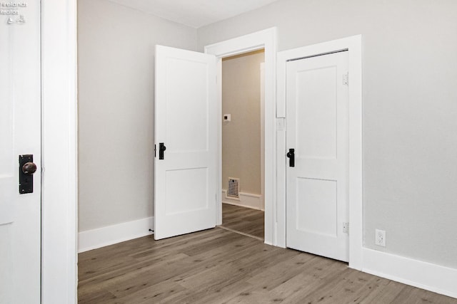 713 Madison St, Port Clinton, OH 43452 - unfurnished bedroom featuring wood finished floors and baseboards