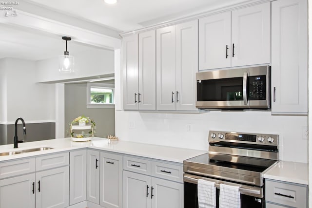 713 Madison St, Port Clinton, OH 43452 - kitchen with stainless steel appliances, a sink, light countertops, pendant lighting, and recessed lighting