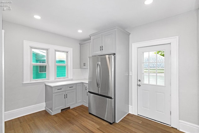 713 Madison St, Port Clinton, OH 43452 - kitchen featuring freestanding refrigerator, wood finished floors, light countertops, recessed lighting, and baseboards