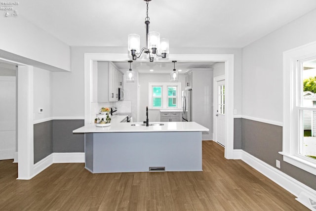 713 Madison St, Port Clinton, OH 43452 - kitchen with a sink, stainless steel appliances, a chandelier, and dark wood-type flooring