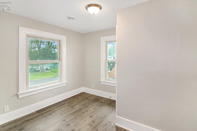 713 Madison St, Port Clinton, OH 43452 - empty room with wood finished floors, baseboards, and a smoke detector