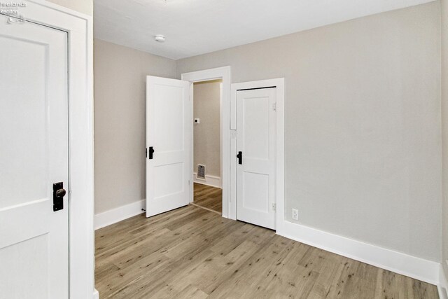 713 Madison St, Port Clinton, OH 43452 - unfurnished bedroom with light wood-type flooring and baseboards