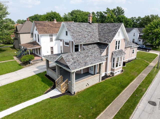 718 E Main St, Bellevue, OH 44811 - view of front of house with a high end roof, covered porch, a front yard, and a chimney