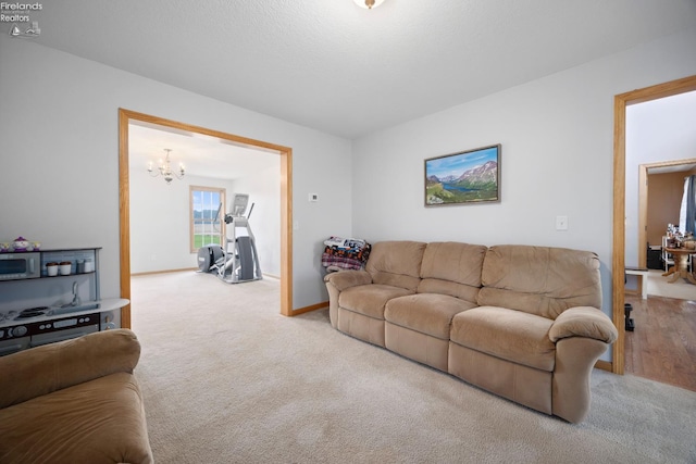 4936 Gibbs Rd, Norwalk, OH 44857 - living area with carpet, a chandelier, and baseboards