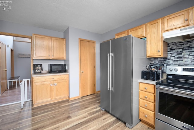 4936 Gibbs Rd, Norwalk, OH 44857 - kitchen featuring appliances with stainless steel finishes, under cabinet range hood, light wood-style floors, backsplash, and light brown cabinets