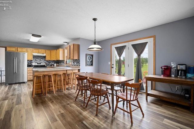 4936 Gibbs Rd, Norwalk, OH 44857 - dining space featuring wood finished floors, french doors, and a textured ceiling
