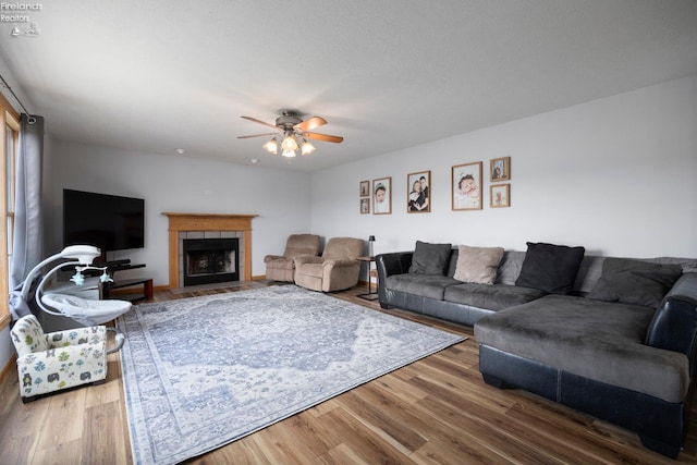 4936 Gibbs Rd, Norwalk, OH 44857 - living room with a ceiling fan, wood finished floors, and a tile fireplace