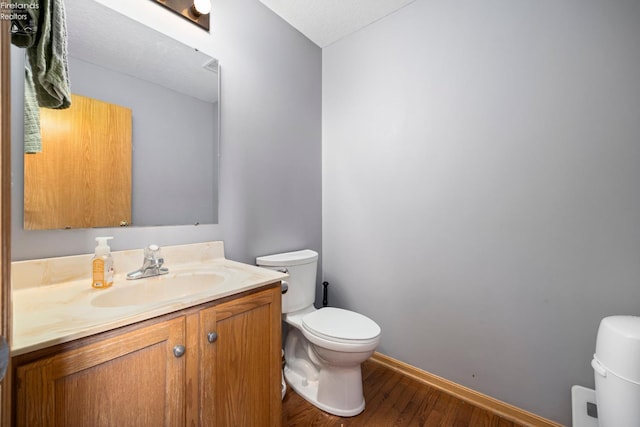 4936 Gibbs Rd, Norwalk, OH 44857 - bathroom featuring toilet, wood finished floors, vanity, and baseboards